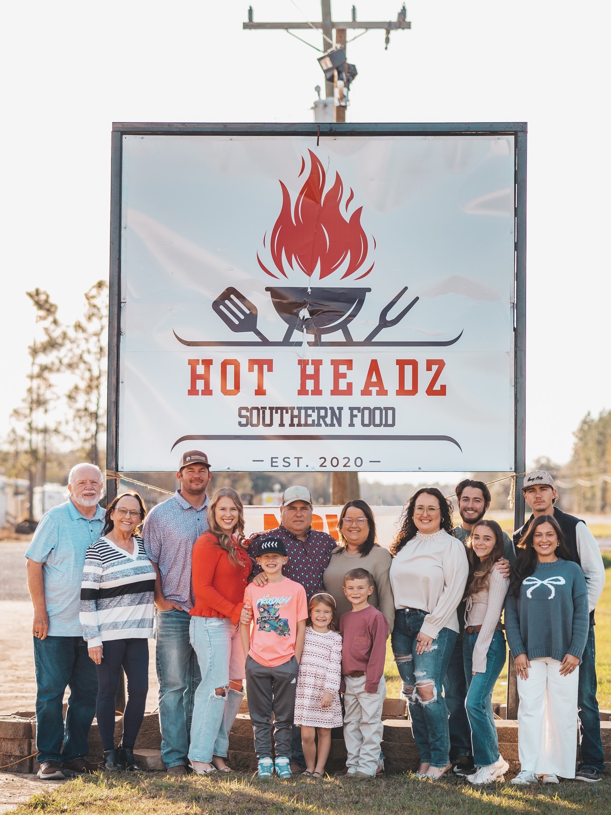 The whole family at the Hot Headz sign